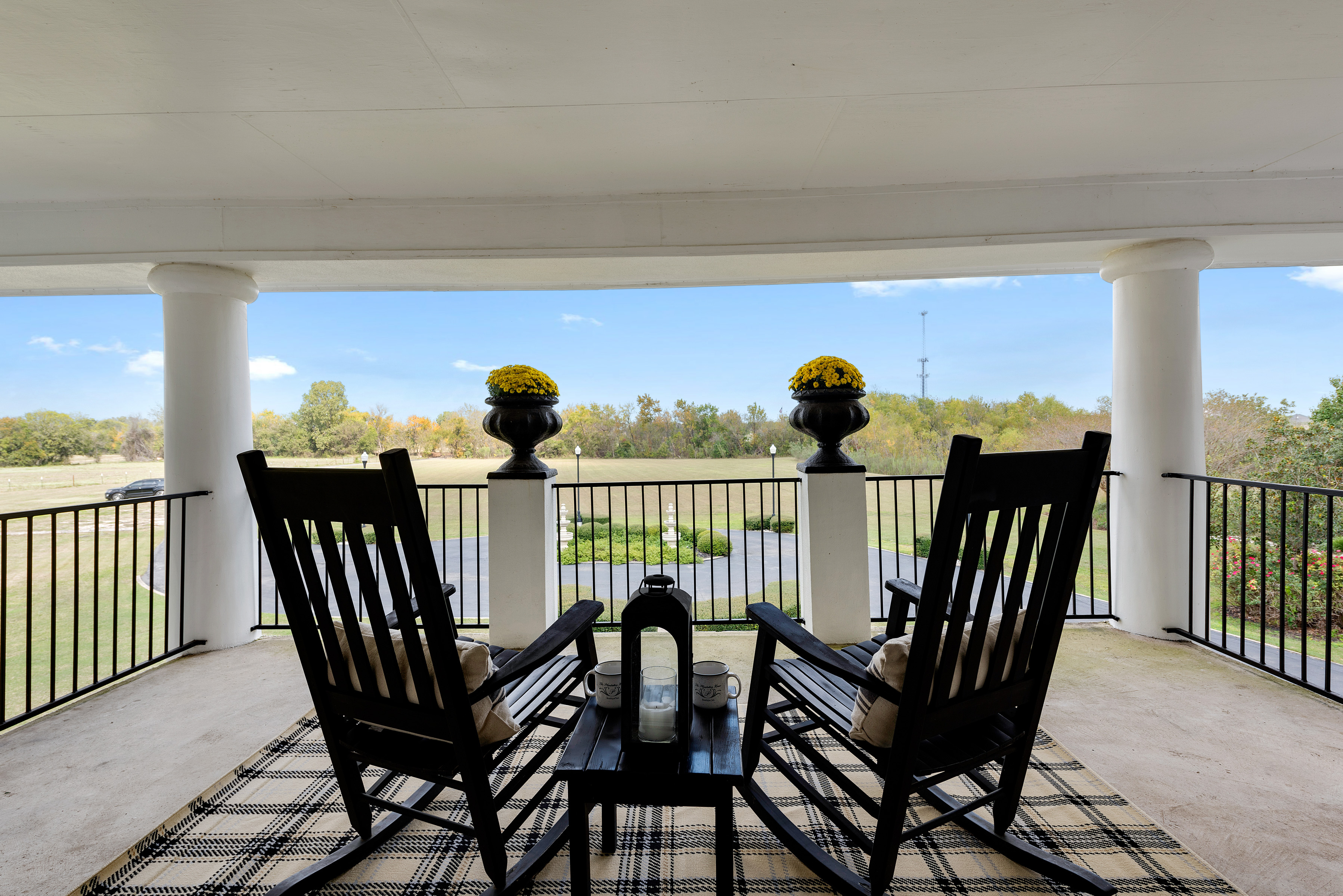 two black rocking chairs on the porch